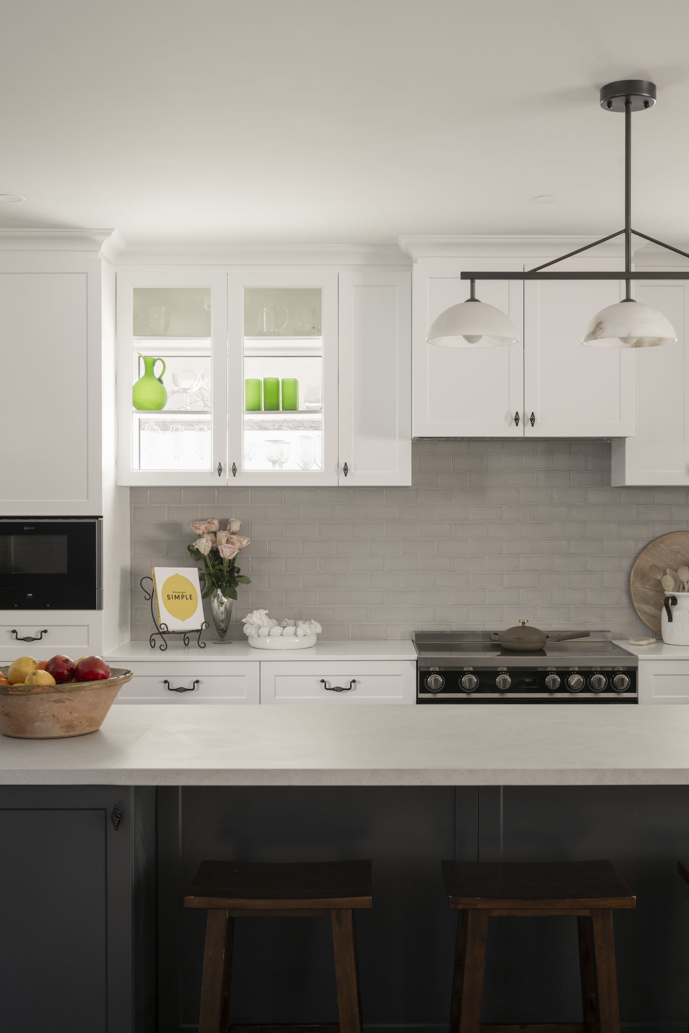 Kitchen with charcoal island and shaker cabinetry